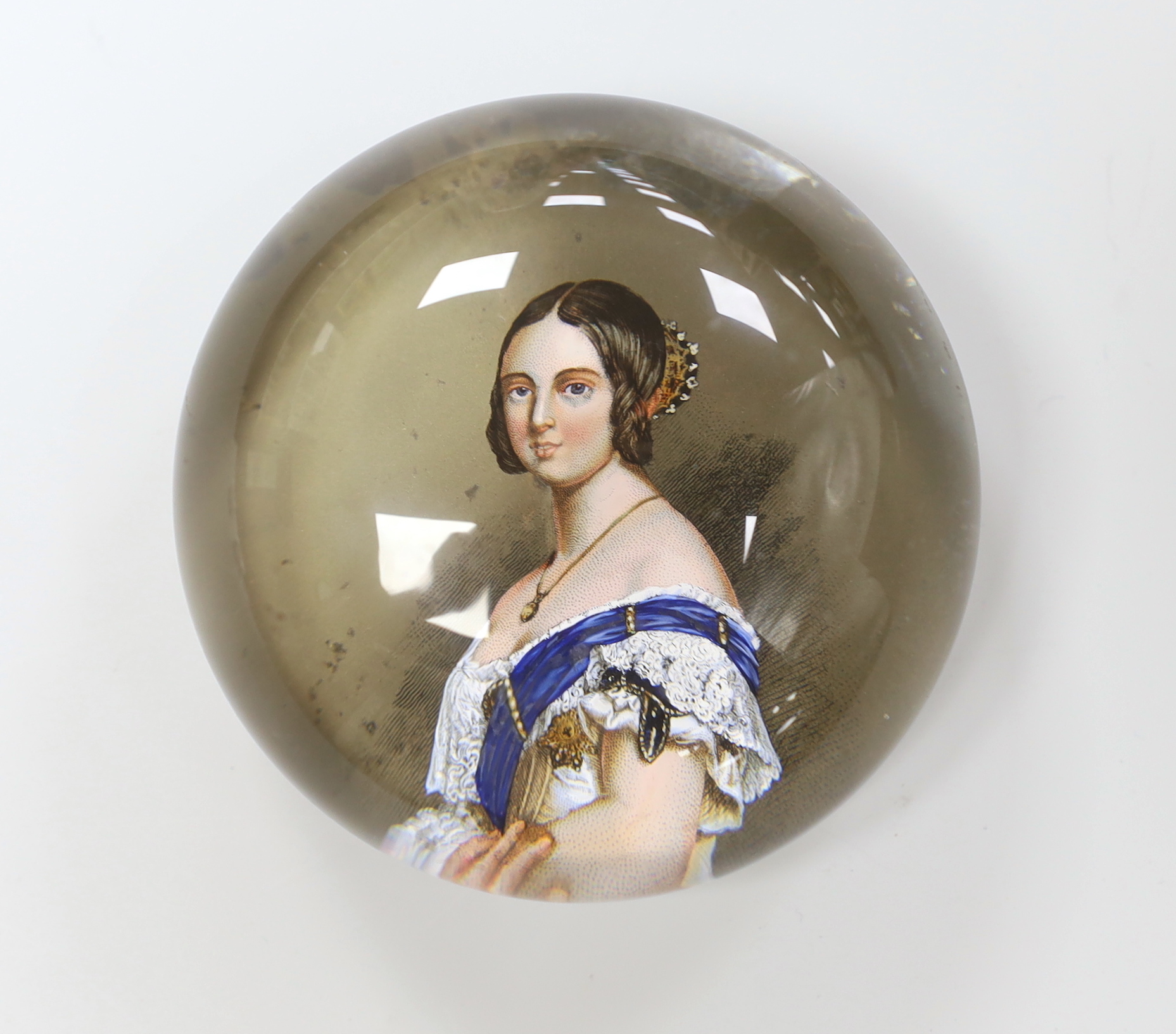 A Queen Victoria reverse decorated glass paperweight, approximately 7.5cm diameter